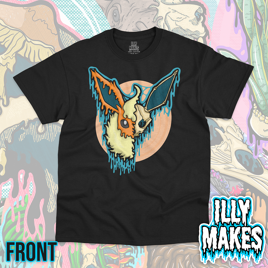 Black unisex tee featuring the Drippy Fire Fox Skull design by Illymakes, with an orange and cream fox-like face, half skull detail, fluffy cream fur, blue dripping accents, and a peach circular background.