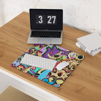 Drippy Pokémon Skull Collage mousepad with a white keyboard and mouse on a wooden desk in front of a laptop.